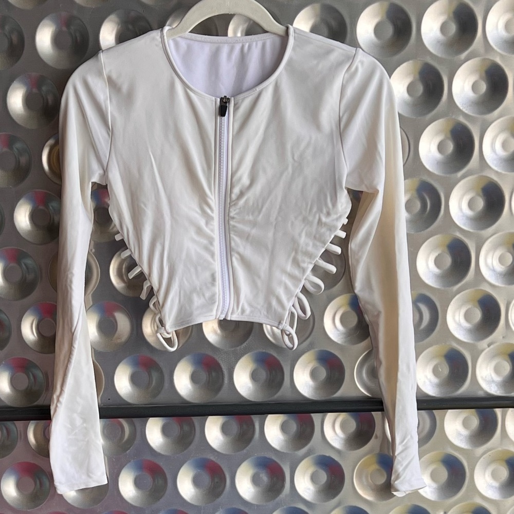 White cropped zip up top with side cutouts